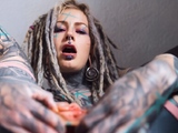 Gorgeous tattooed girl fucks her ass with a big dildo
